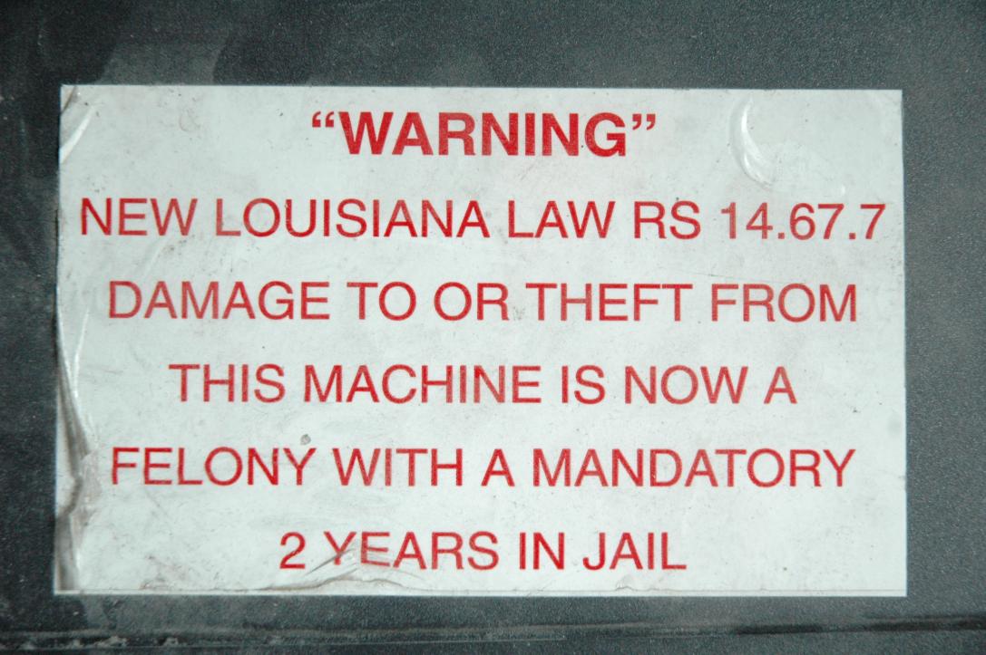 "WARNING"/New Louisiana Law RS 14.67.7/Damage to or theft from this machine is now a felony with a mandatory 2 years in Jail/This sticker from a soft drink vending machine in a hotel decorated my VCR vor many years